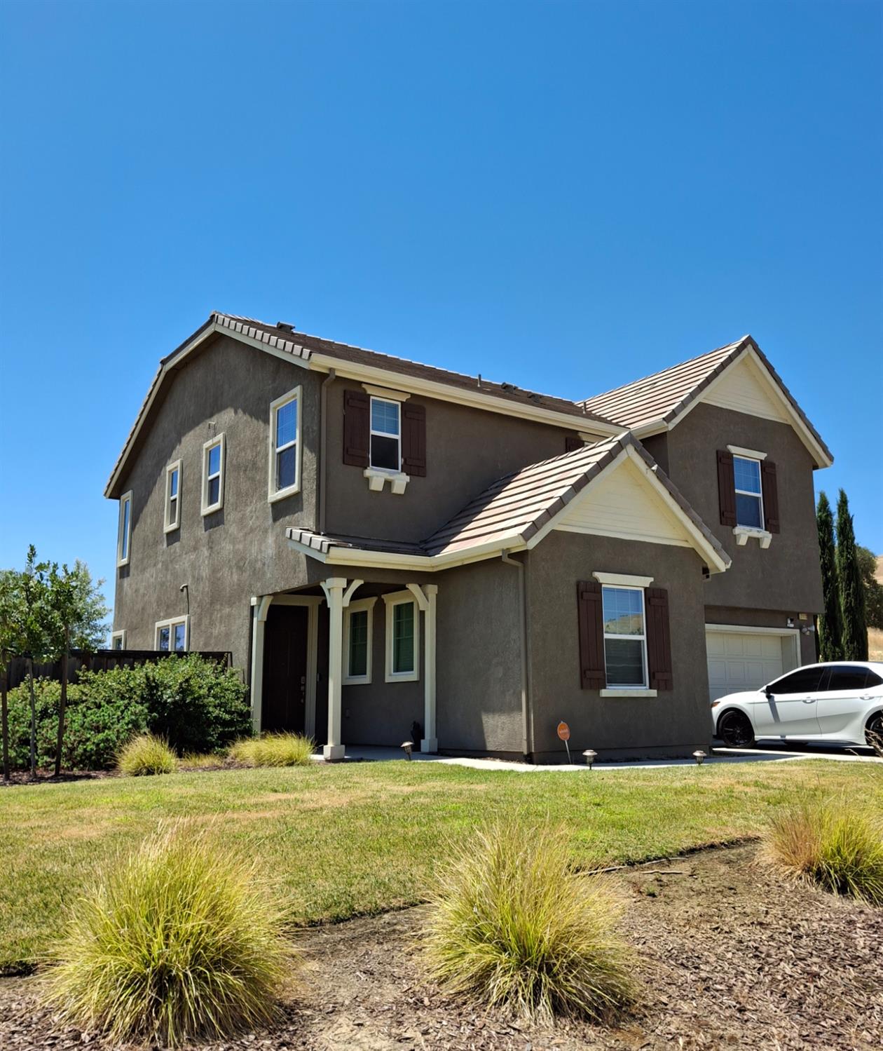 21113 Pinot Noir Drive Patterson, CA 95363 - Photo 1 of 5 a front view of a house with a yard