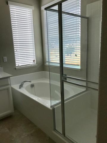 21113 Pinot Noir Drive Patterson, CA 95363 - Photo 5 of 5 a bathroom with a bathtub and a window