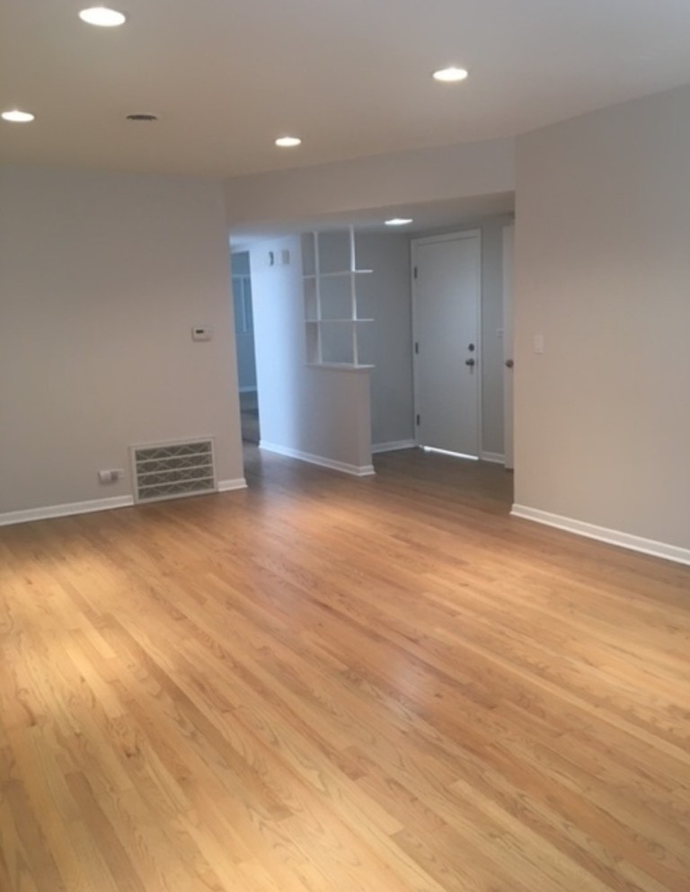 2919 West Irving Park Road Chicago, IL 60618 - Photo 11 of 11 an empty room with wooden floor and windows
