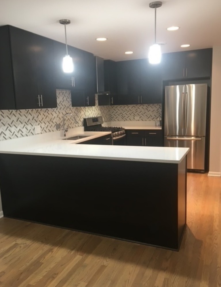 2919 West Irving Park Road Chicago, IL 60618 - Photo 10 of 11 a large kitchen with a large counter top