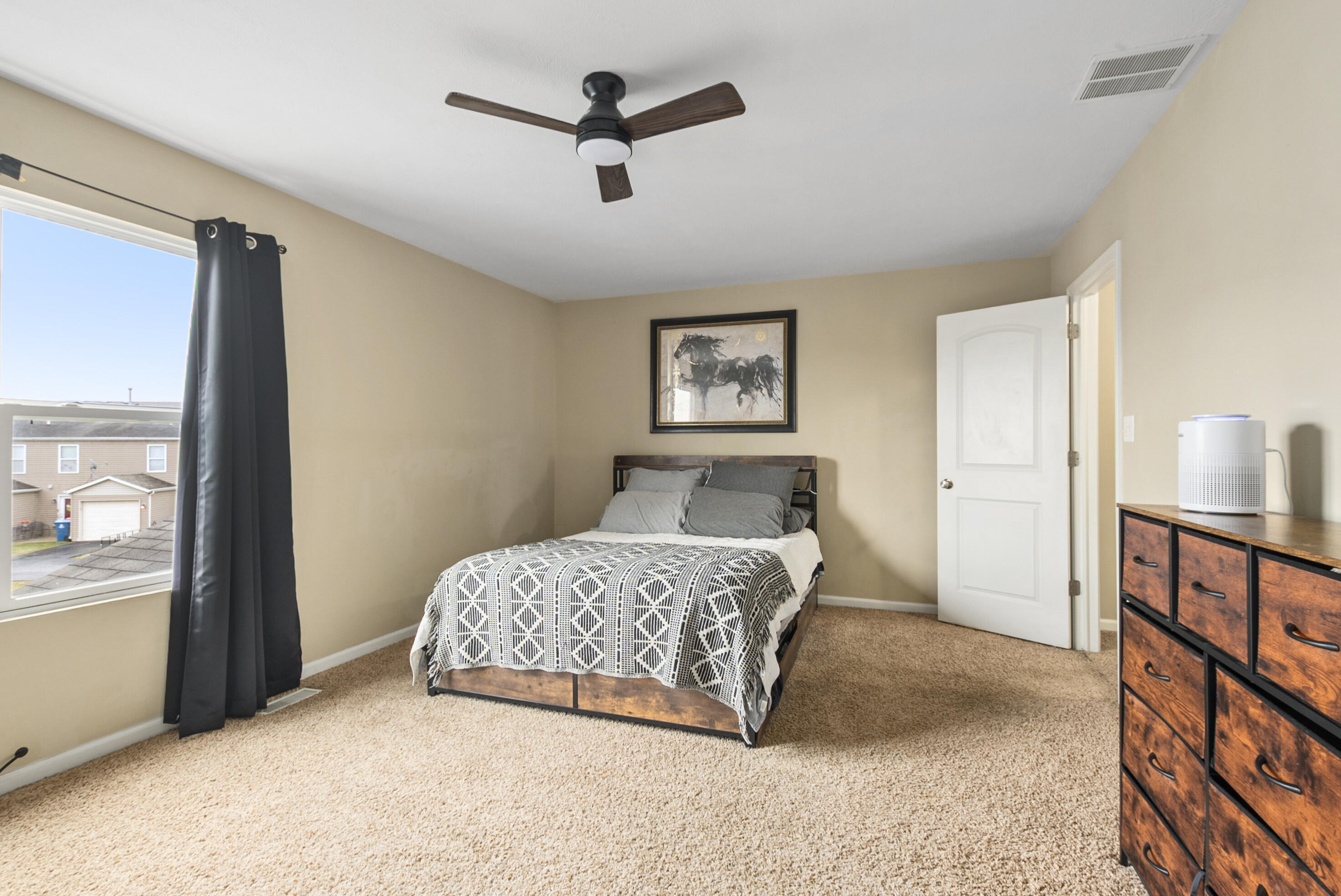 14019 Paramount Way Cedar Lake, IN 46303 - Photo 7 of 11 a bedroom with a large bed and a chandelier