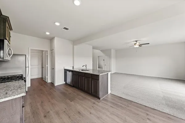 a kitchen with stainless steel appliances a refrigerator and a stove top oven
