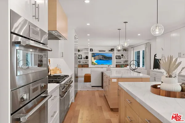 a kitchen with counter top space a sink and stainless steel appliances