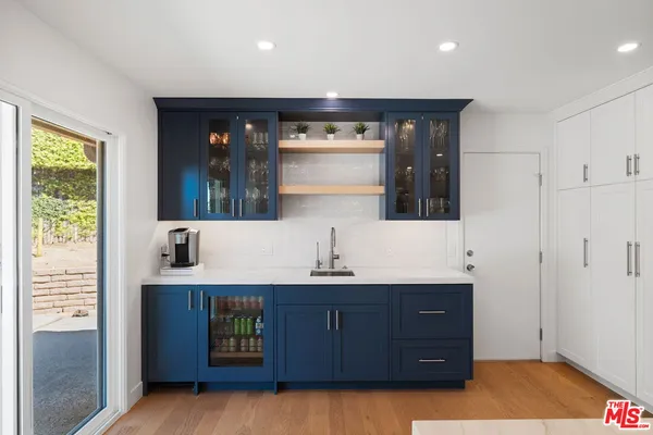 a kitchen with a sink and a refrigerator