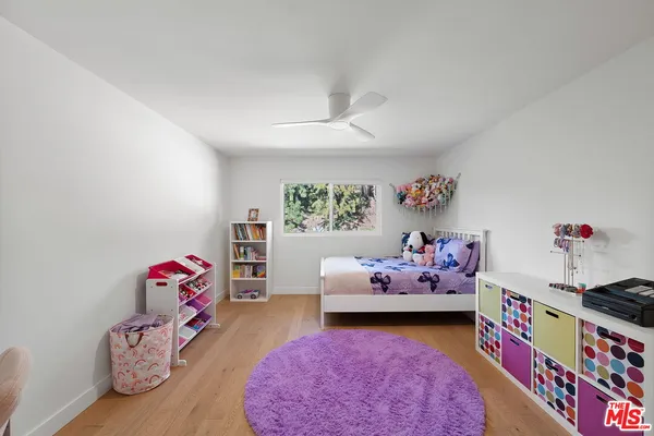 a bedroom with toys and a wooden floor