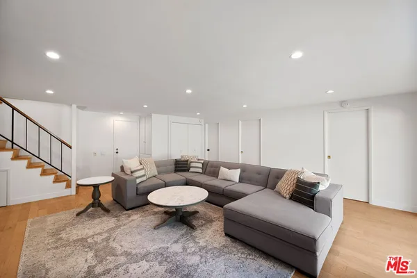 a living room with furniture and a dining table