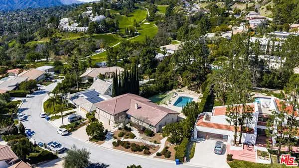 an aerial view of multiple houses with yard