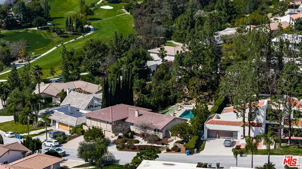 an aerial view of multiple houses with yard
