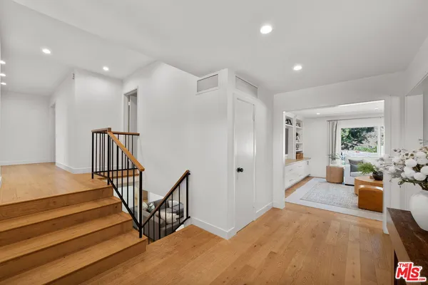 a view of a livingroom with furniture and stairs