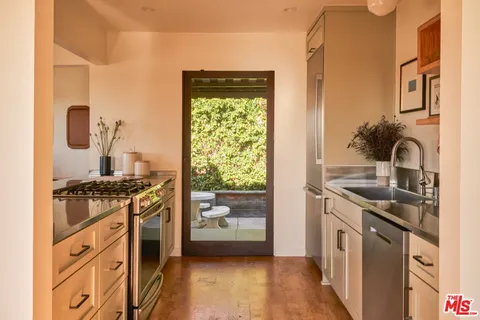 a kitchen with stainless steel appliances granite countertop a stove and a sink