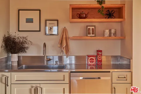 a kitchen with kitchen island a sink and cabinets
