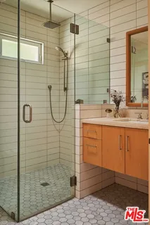 a bathroom with a shower and a sink