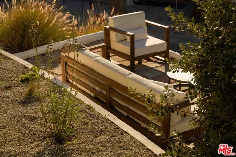 a roof deck with the table and chairs