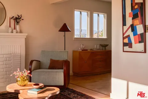 a living room with furniture and a lamp