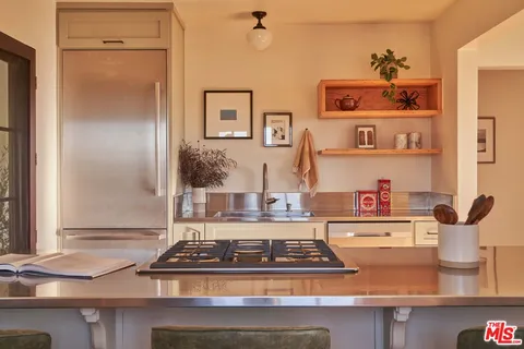 a kitchen with a stove and cabinets
