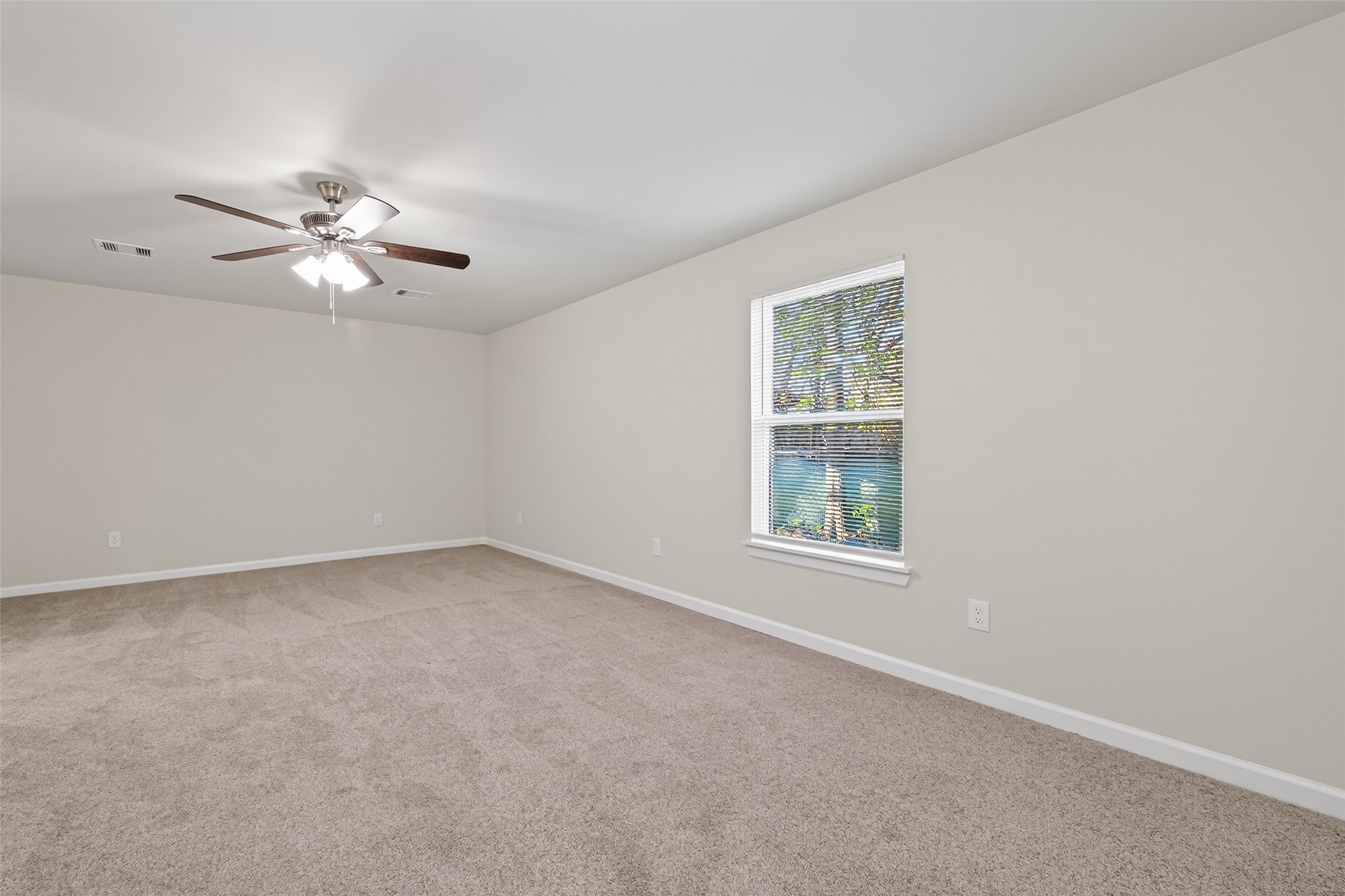 1238 Hopper Road Houston, TX 77037 - Photo 18 of 40 an empty room with a window and a ceiling fan