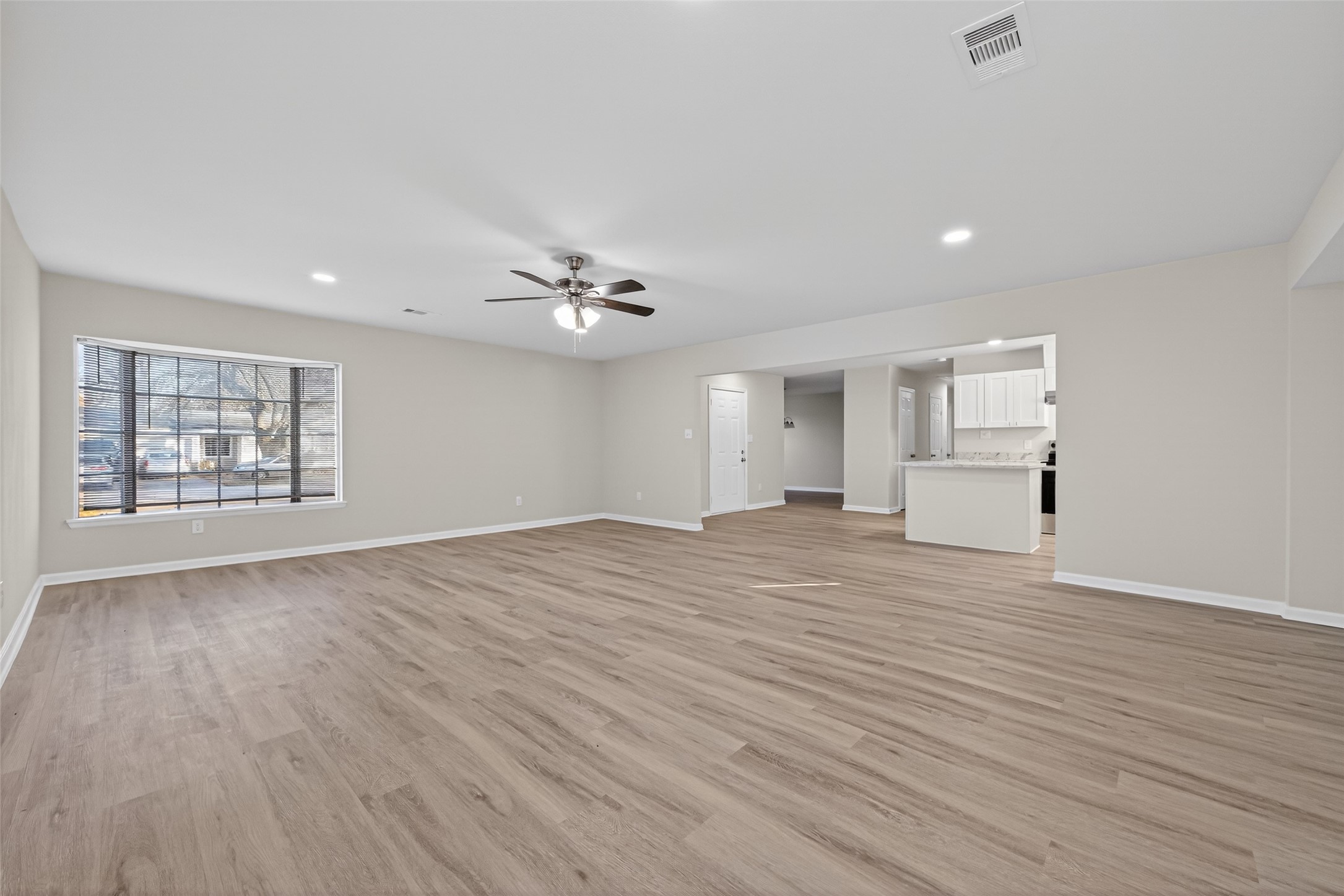 1238 Hopper Road Houston, TX 77037 - Photo 23 of 40 a view of empty room with wooden floor and fan