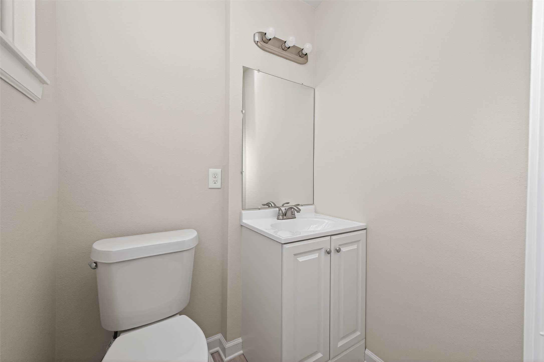 1238 Hopper Road Houston, TX 77037 - Photo 30 of 40 a bathroom with a toilet a sink and mirror