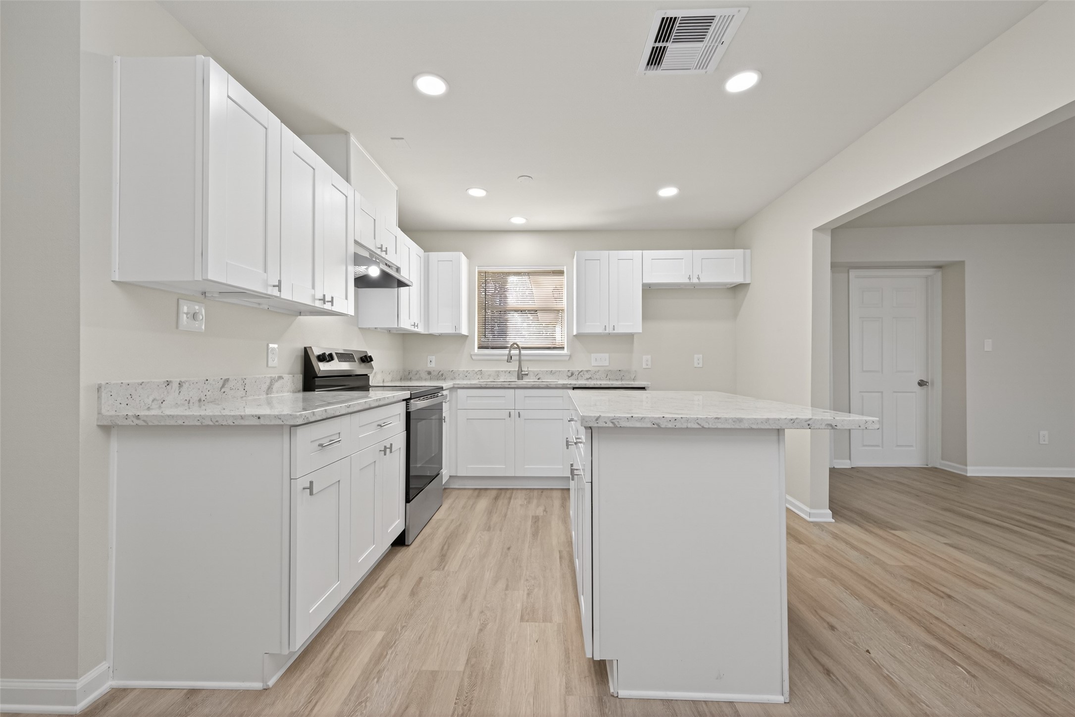 1238 Hopper Road Houston, TX 77037 - Photo 8 of 40 a kitchen with granite countertop white cabinets and wooden floor