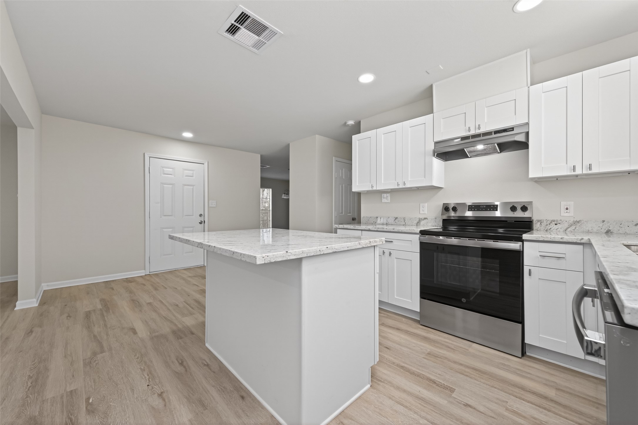 1238 Hopper Road Houston, TX 77037 - Photo 10 of 40 a kitchen with a sink a stove and cabinets