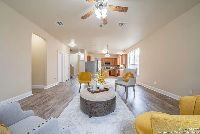 a living room with furniture and a chandelier