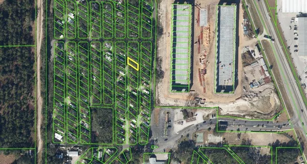 an aerial view of a residential apartment building with a yard