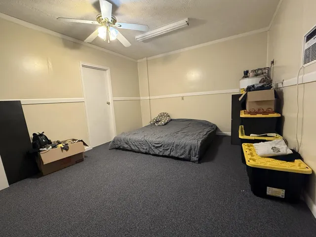 a bedroom with bed and a chandelier