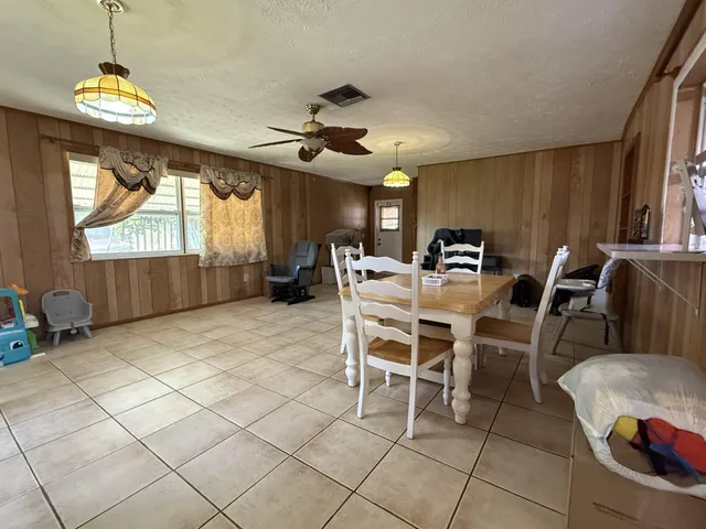 a dining room with furniture and window