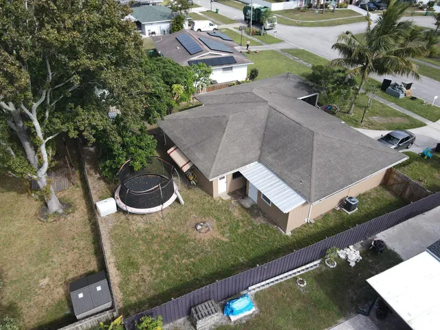 an aerial view of a house with a yard basket ball court and outdoor seating
