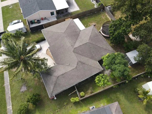 an aerial view of residential houses with outdoor space and street view