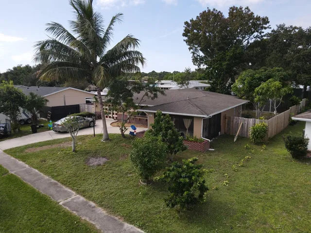 an aerial view of a house with swimming pool garden and patio