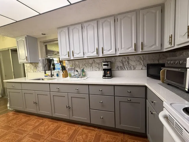 a kitchen with stainless steel appliances granite countertop a sink and cabinets
