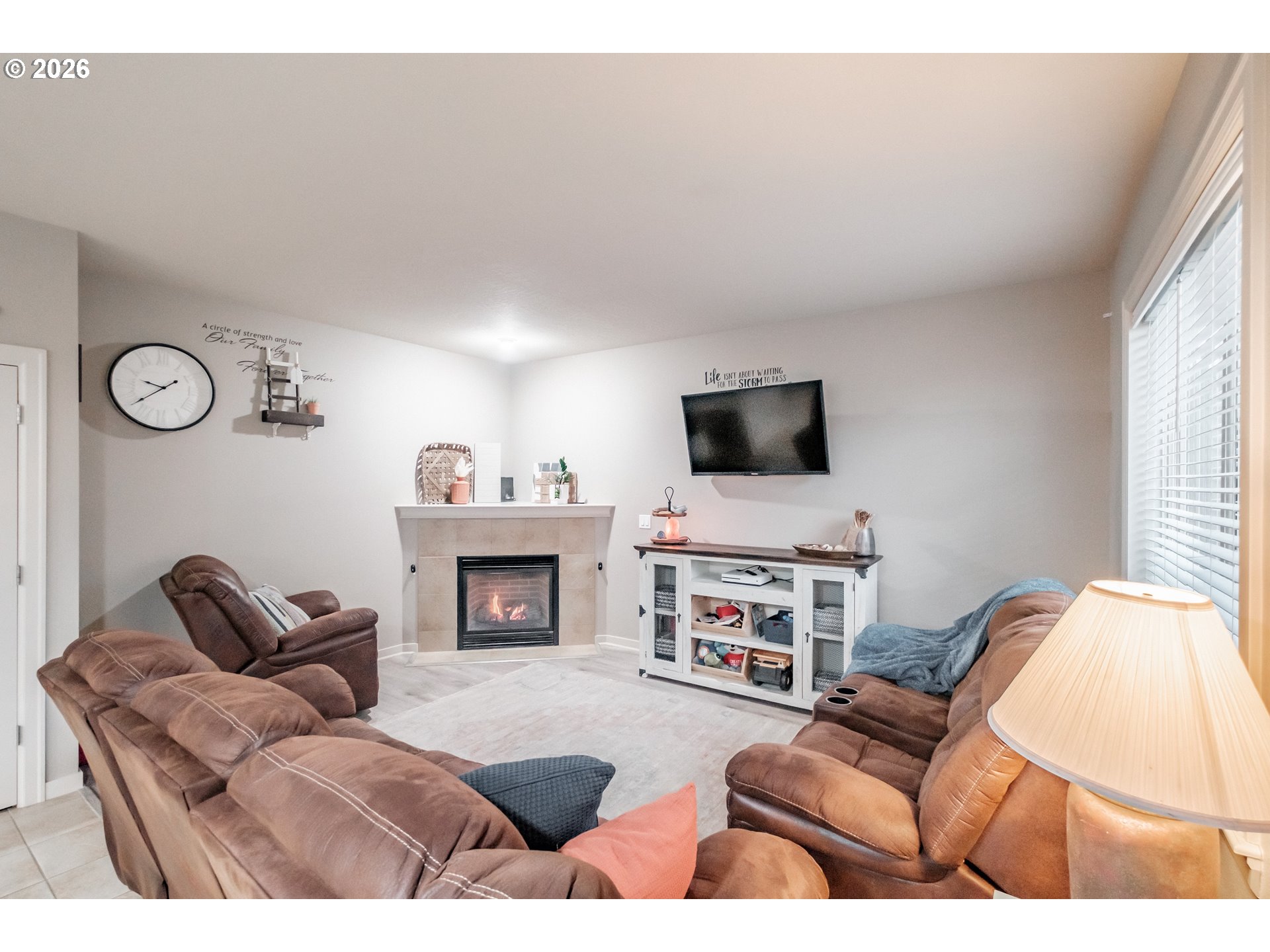 1000 Tasha Way Lebanon, OR 97355 - Photo 10 of 48 a living room with furniture a fireplace and a flat screen tv