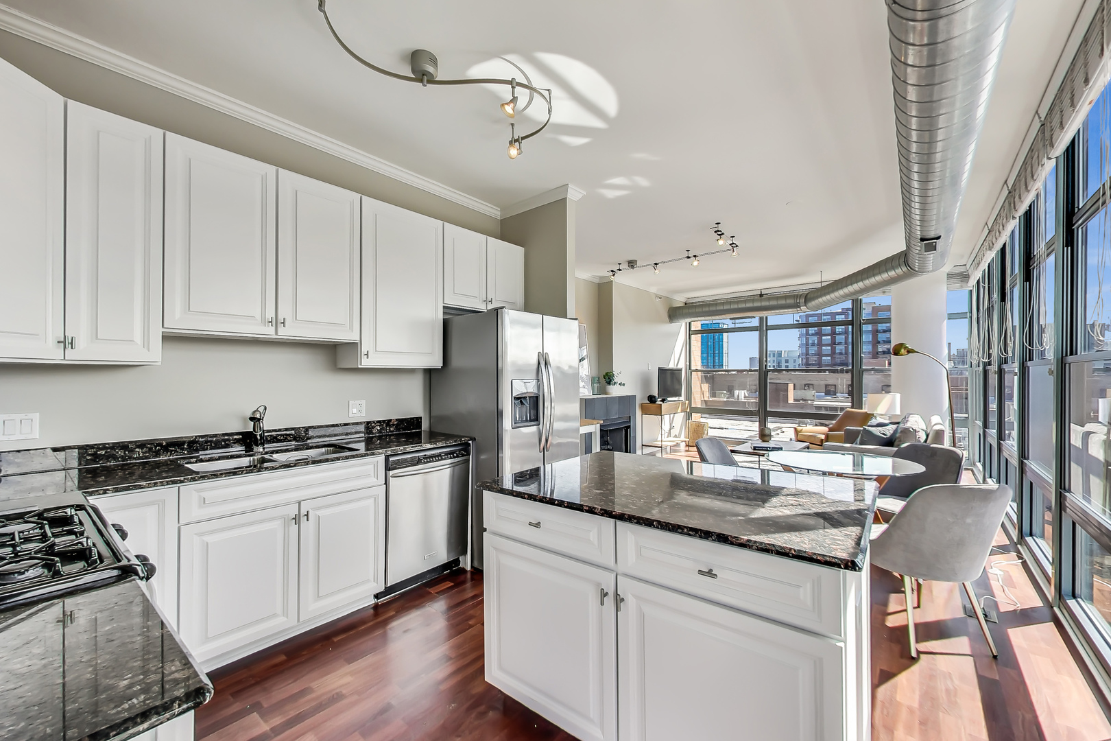 1200 West Monroe Street, Unit 511 Chicago, IL 60607 - Photo 6 of 12 a kitchen with granite countertop a sink stainless steel appliances and cabinets