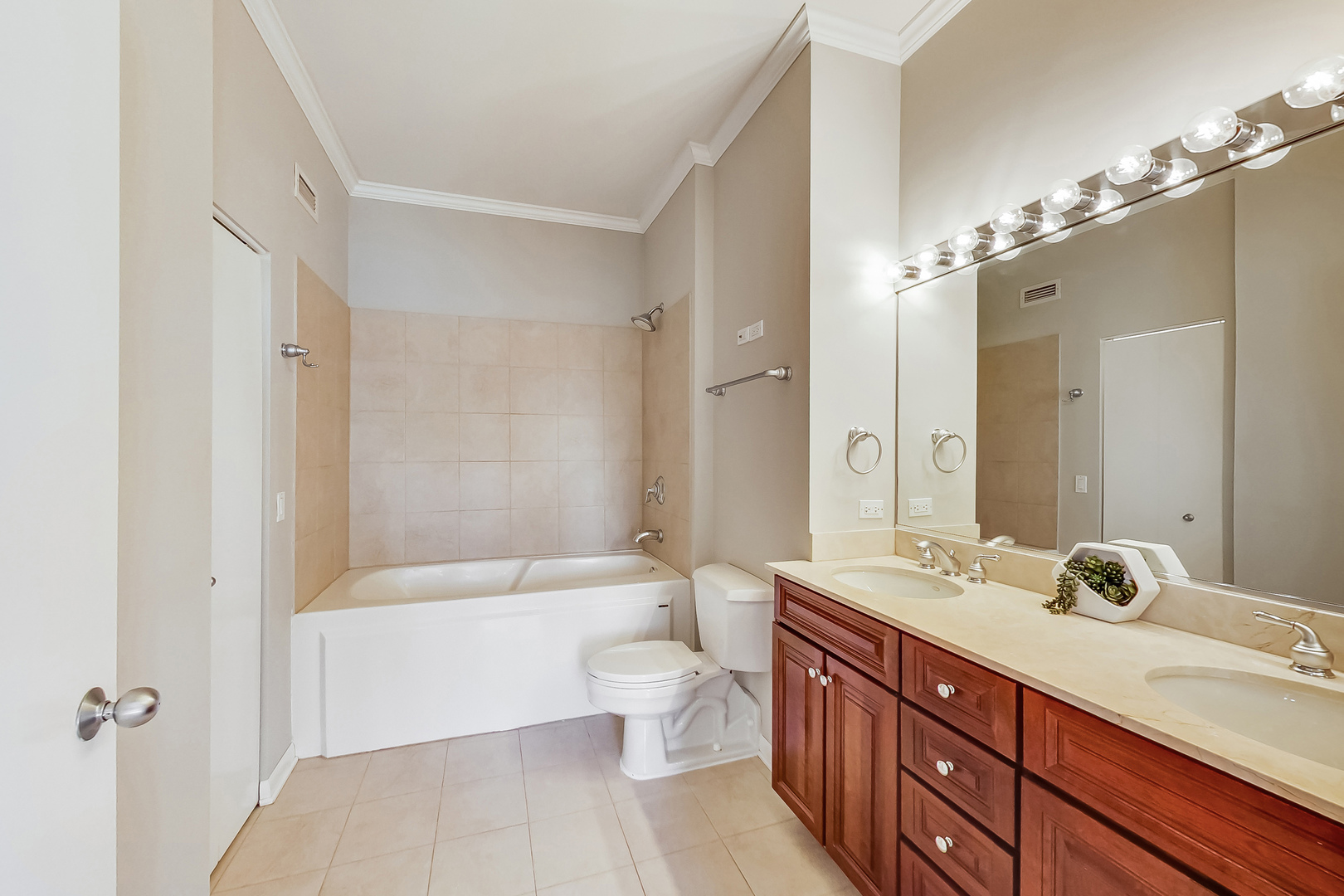 1200 West Monroe Street, Unit 511 Chicago, IL 60607 - Photo 8 of 12 a bathroom with a double vanity sink toilet mirror and bathtub