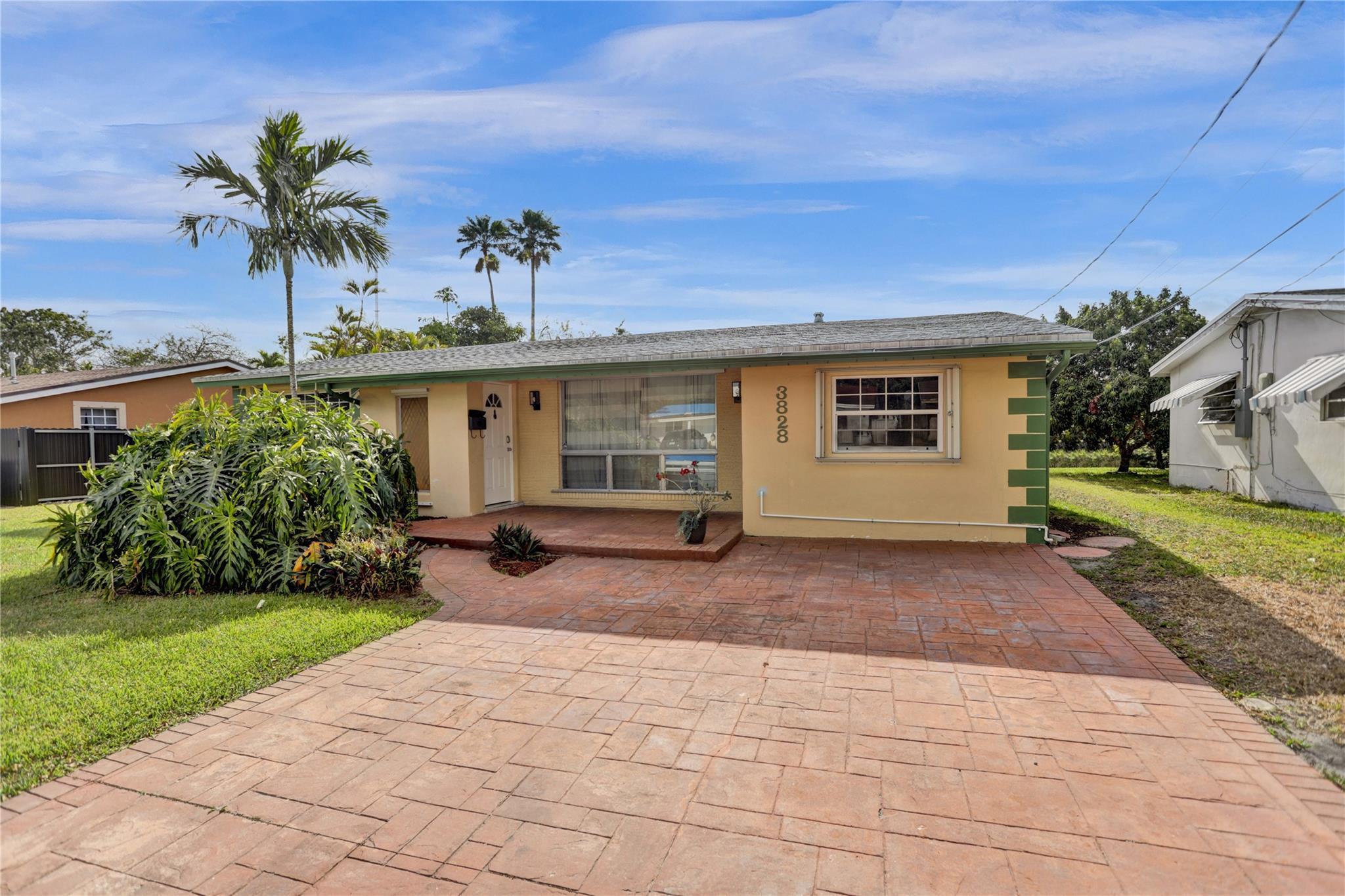 3828 East Shore Road Miramar, FL 33023 - Photo 1 of 33 a view of a house with a yard and potted plants
