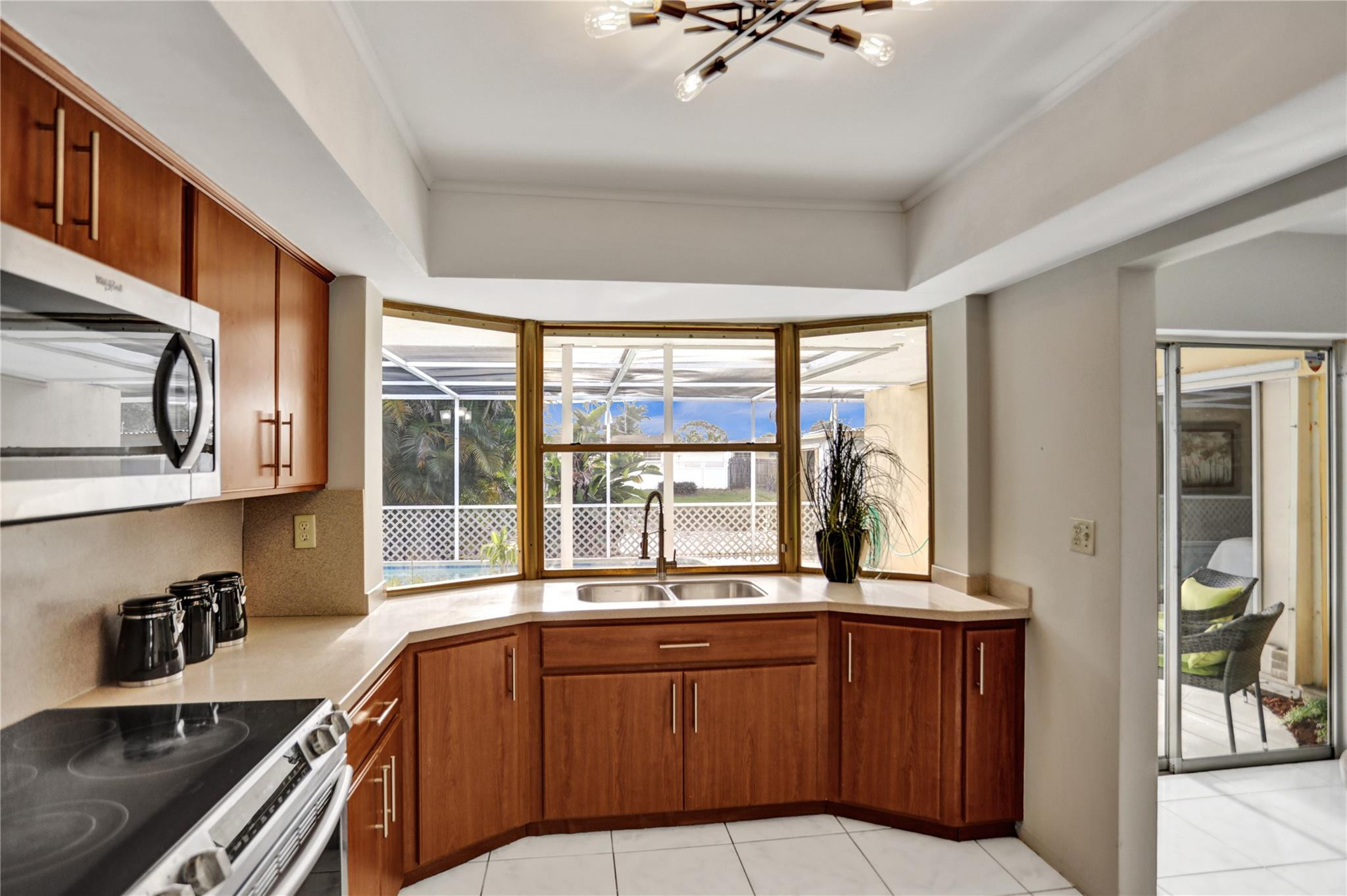 3828 East Shore Road Miramar, FL 33023 - Photo 14 of 33 a kitchen with stainless steel appliances granite countertop a stove a sink and a microwave