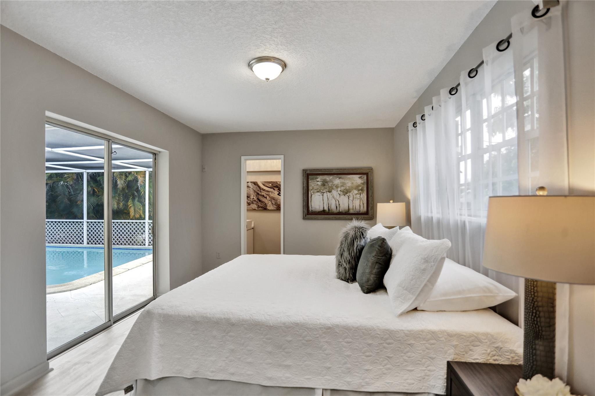 3828 East Shore Road Miramar, FL 33023 - Photo 27 of 33 a bedroom with a large bed and a window