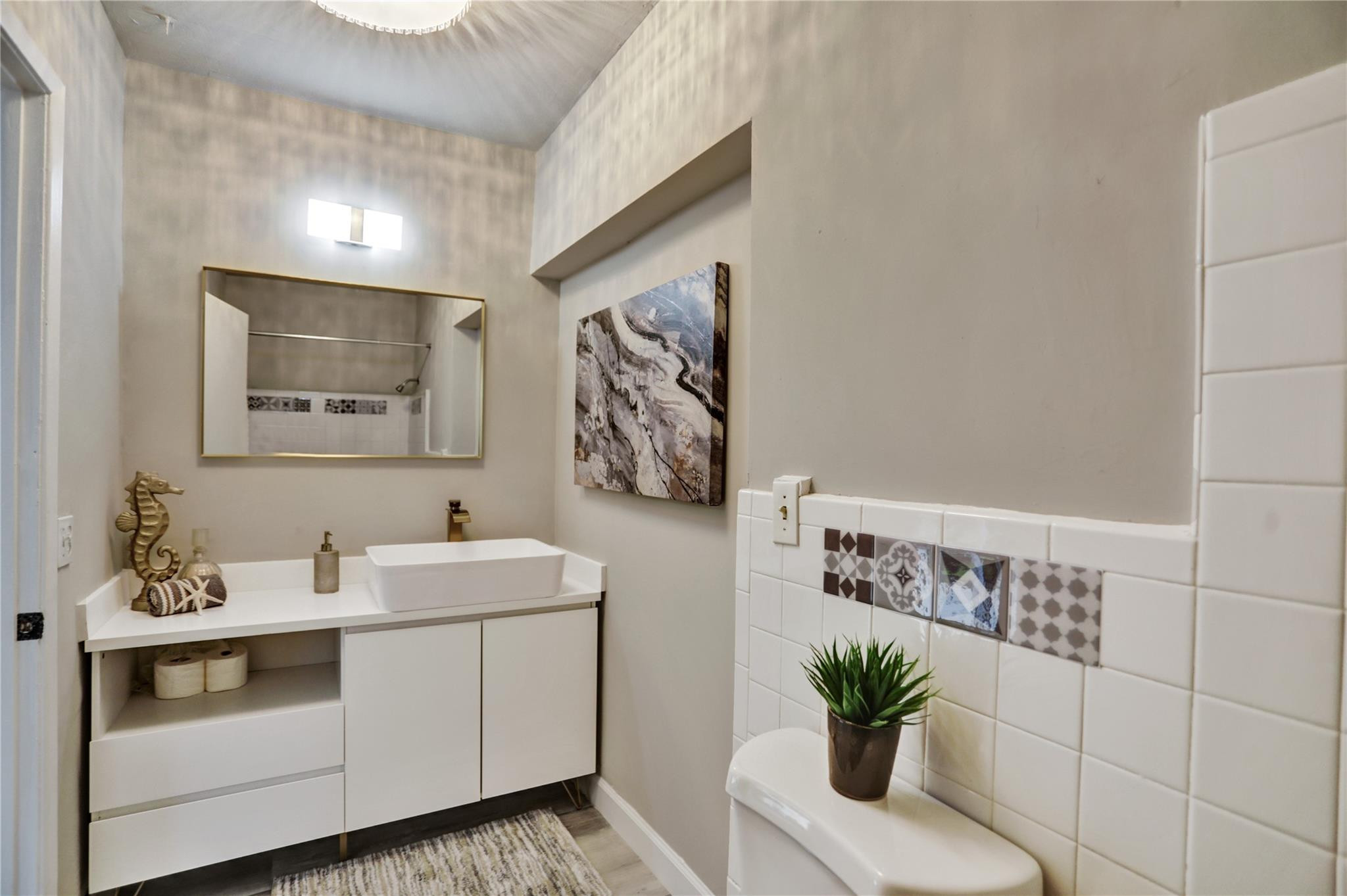 3828 East Shore Road Miramar, FL 33023 - Photo 32 of 33 a bathroom with a sink a mirror and a potted plant