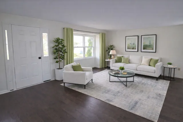 a living room with furniture and a potted plant