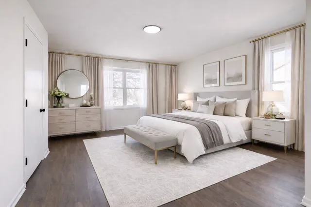 a spacious bedroom with a bed and a large window