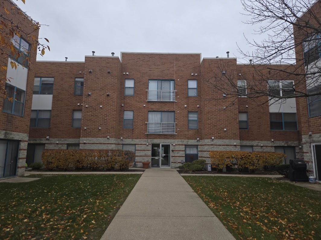 a view of a brick building next to a yard