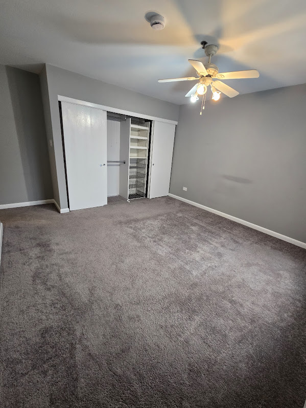 3255 Kirchoff Road, Unit 301 Rolling Meadows, IL 60008 - Photo 17 of 24 a view of an empty room with a chandelier fan