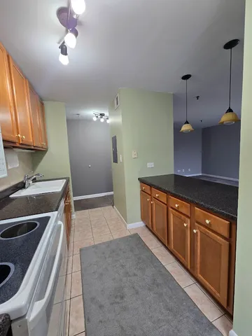 a large kitchen with stainless steel appliances granite countertop a sink and a stove