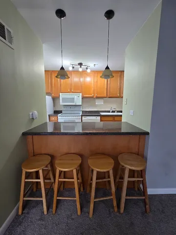 a kitchen with a table chairs and utility room