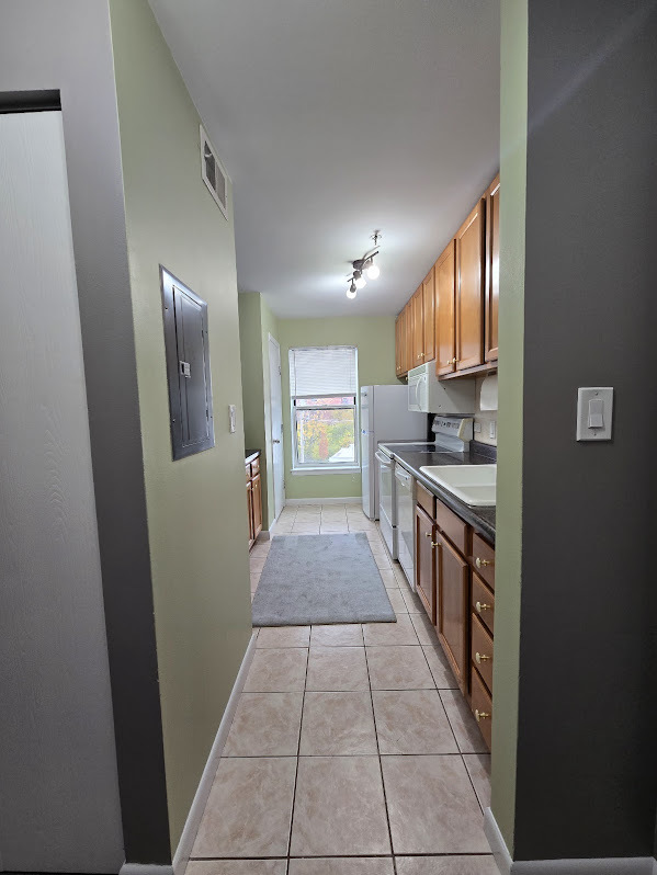 3255 Kirchoff Road, Unit 301 Rolling Meadows, IL 60008 - Photo 6 of 24 a kitchen with stainless steel appliances granite countertop a refrigerator and a sink