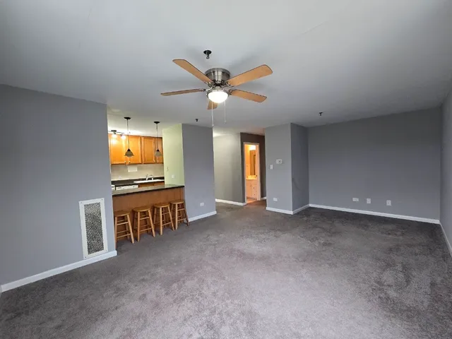 a view of game room with windows and ceiling fan