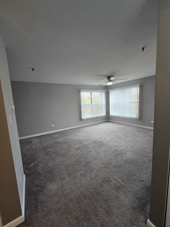 3255 Kirchoff Road, Unit 301 Rolling Meadows, IL 60008 - Photo 9 of 24 an empty room with windows