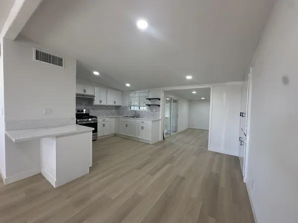 a view of kitchen and wooden floor