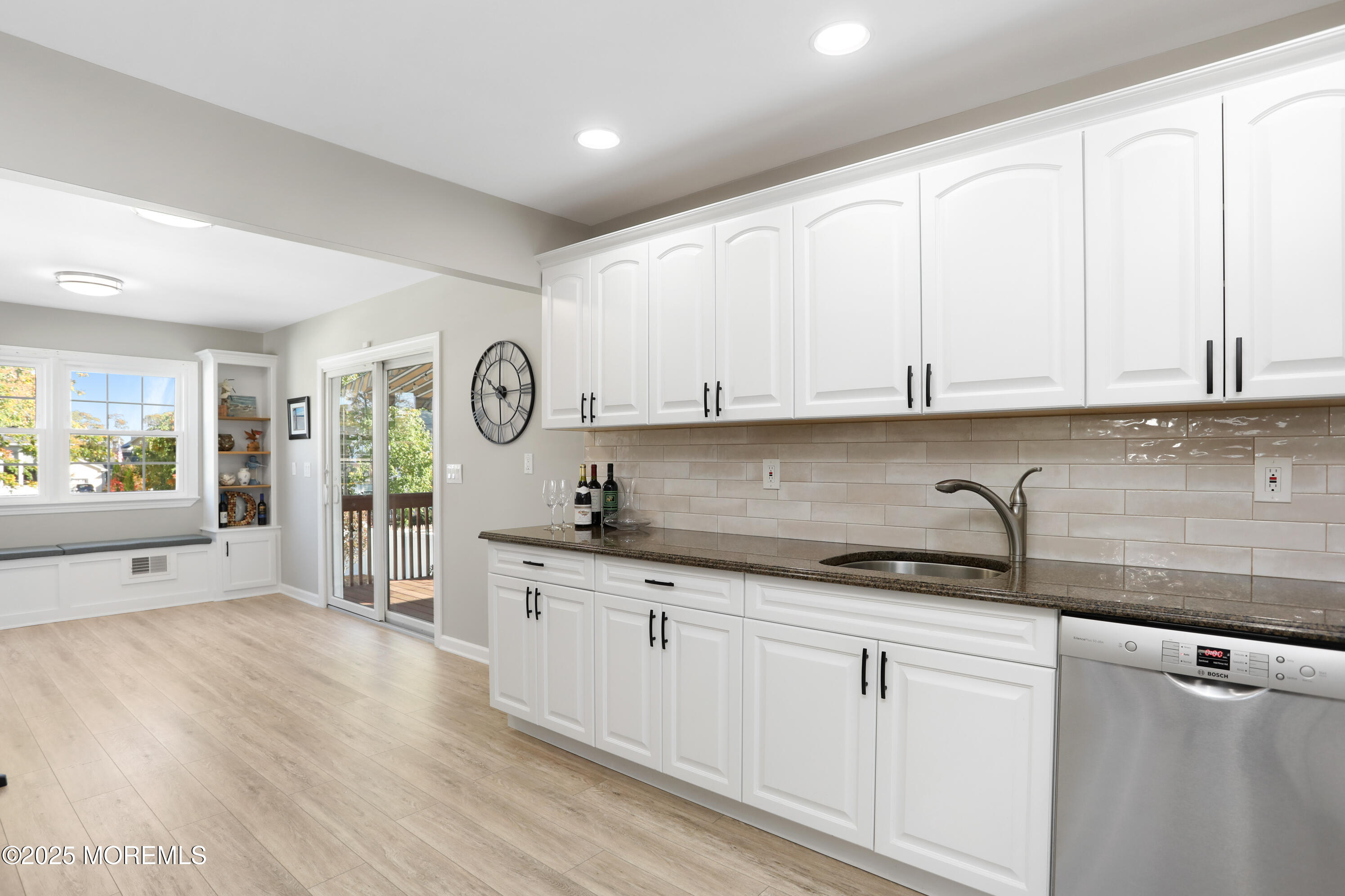 910 Ocean Road Spring Lake Heights, NJ 07762 - Photo 11 of 31 a kitchen with granite countertop white cabinets and stainless steel appliances